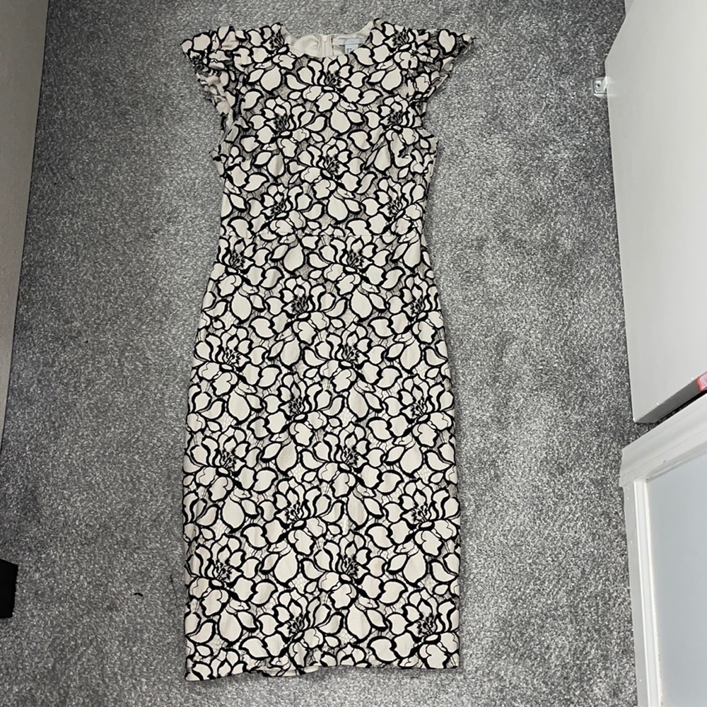 Cream dress with small sleeves and floral overlay